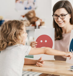 Emotion emoticons used by a psychologist during a therapy session with a child with an autism spectrum disorder.